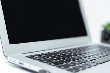 Close up of laptop with blank screen on white background, stock photo