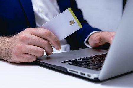 Man holding credit card and using laptop computer. Online shopping concept.の写真素材