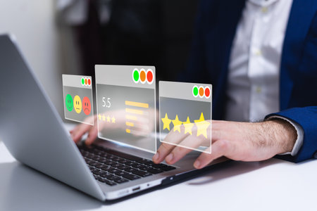Businessman using a laptop with rating concept on the screen. All screen graphics are made up.の写真素材