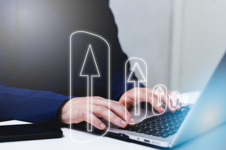 Businessman working on laptop with digital arrow icon. Success concept.の写真素材