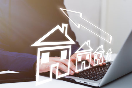 Businessman using laptop with drawing house on screen. Real estate conceptの写真素材