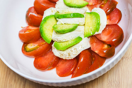 Tomato salad with mozzarella cheese and avocado - Healthy food styleの写真素材