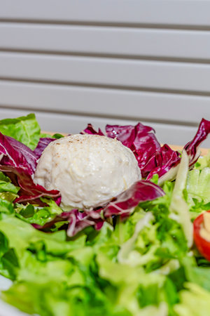 Salad with cheese on white background, close upの写真素材