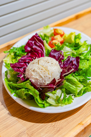 Salad with poached egg on white plate. Healthy food conceptの写真素材