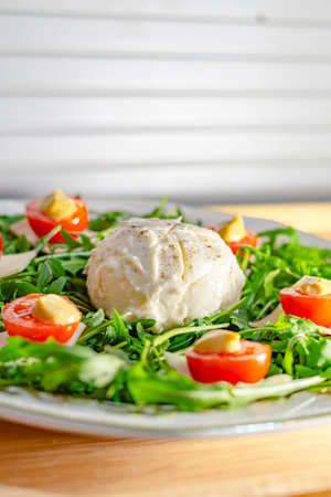Salad with mozzarella cheese, cherry tomatoes and arugulaの写真素材