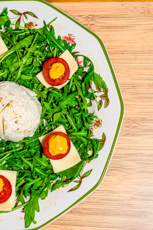 Salad with arugula, cheese and poached egg.の写真素材
