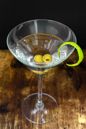 Martini with olives and pepper on a wooden background. Close up.の写真素材