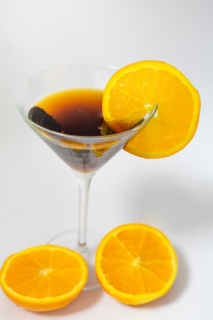 Cocktail in martini glass with orange slices on white backgroundの写真素材