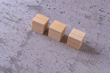 Wooden blocks on a concrete background. Concept of leadership and success.の写真素材