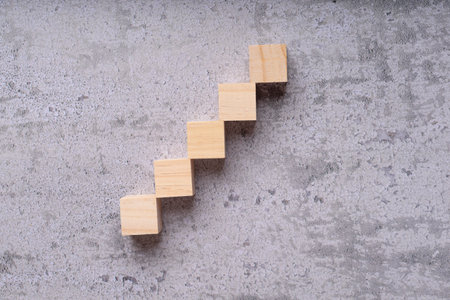 wooden stairs on cement background with copy space, business growth conceptの写真素材