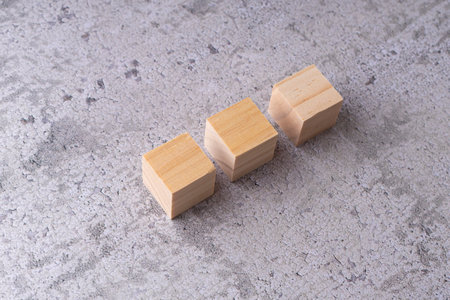 Wooden blocks on a concrete background. The concept of leadership.
