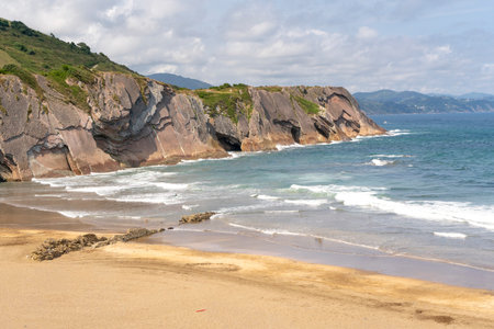 Panoramic image of a serene coastal beach with sand and sea, perfect for holidays, tourism, and relaxation in a calm natural landscape.の写真素材