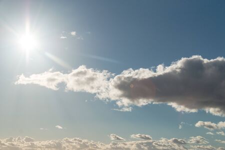 Clouds with a blue sky and a sun