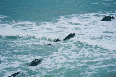 rocks and waves in the water in the sea