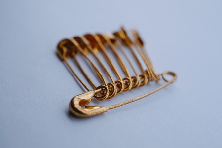metallic golden safety pinの写真素材