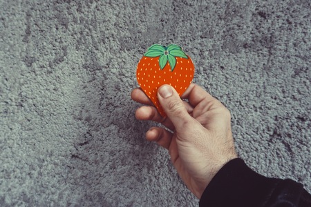 hand with strawberry object decorativeの写真素材
