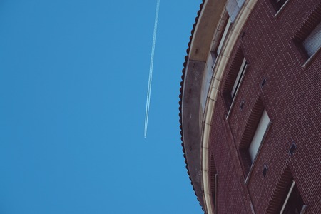 airplane flyin in the blue sky in Bilbao city. Spain.の写真素材