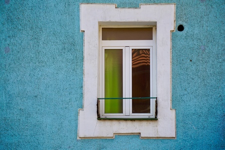 window on the blue facade in Bilbao city. Spain.