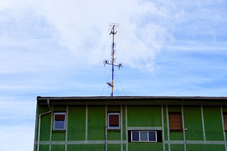 television aerial on the building rooftopの写真素材