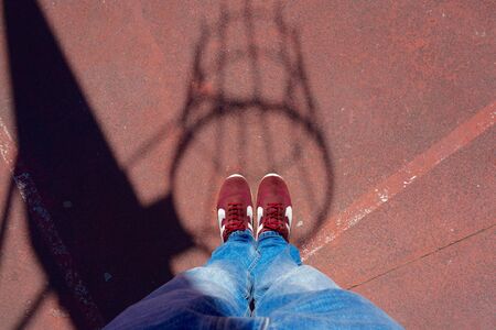 feet and sneakers on the ground in the streetの写真素材