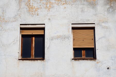 window on the white building facade in the street