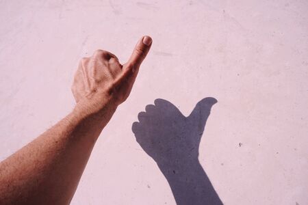 man hand gesturing on the pink wallの写真素材