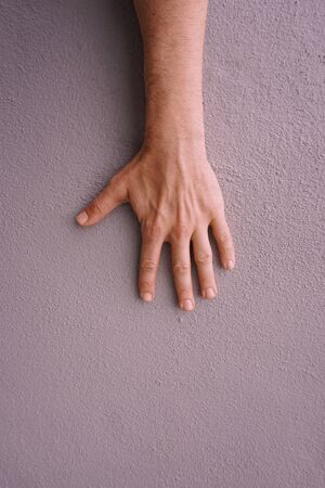 man hand gesturing on the pink wallの写真素材