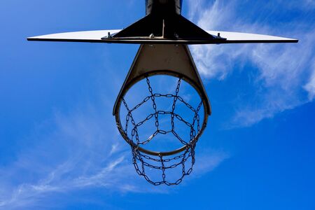 basketball hoop with metallic net and blue sky on the street in Bilbao city spain