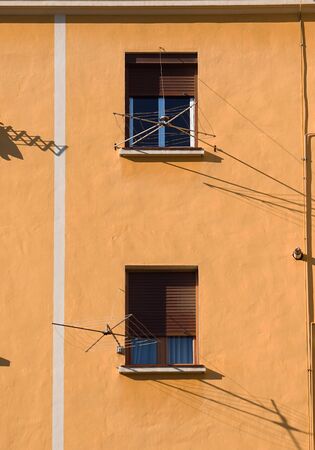 window on the orange facade of the house in Bilbao city Spainの写真素材