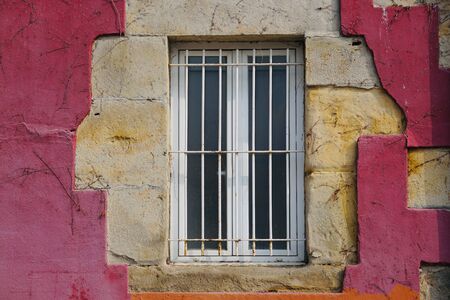 window on the red facade of the house in Bilbao city Spainの写真素材