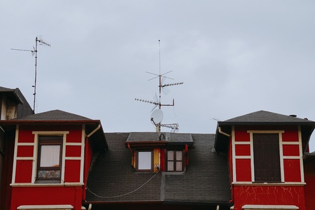 window on the red facade of the house in Bilbao city Spainのeditorial素材