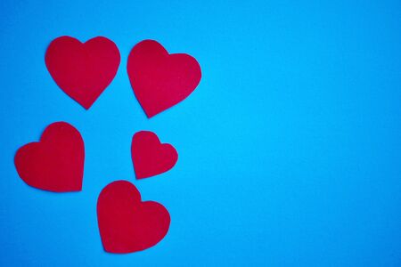 red hearts shapes on the blue bakcground for valentine's dayの写真素材