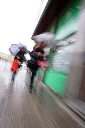 tourist with umbrella walking on the street in Bilbao city Spain, rainy daysの写真素材