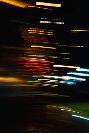colorful lights on the street at night, abstract and multicolored backgroundの写真素材