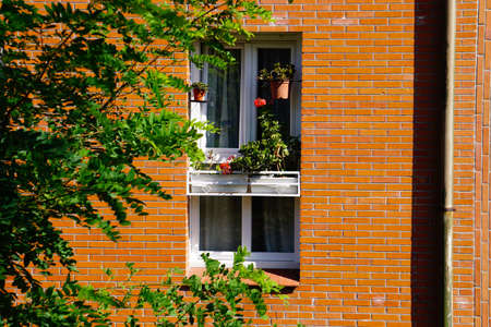 window on the orange facade of the house, architecture in Bilbao city, Spain