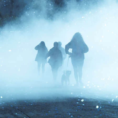 people walking on the street with fog in Bilbao city, Spainの写真素材