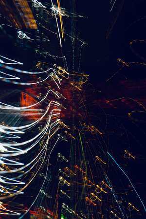 multi colored defocused lights at night on the street, abstract background