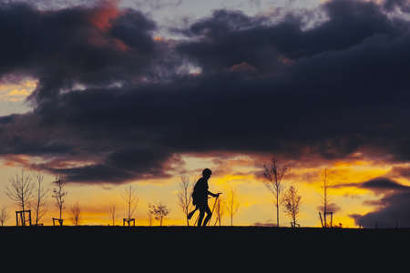people silhouette and sunset in the mountainの写真素材