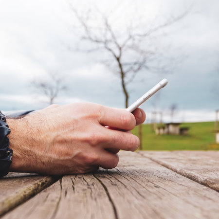 man hand with a smartphone, mobile addiction