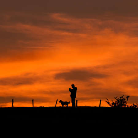 people walking in the country with a beautiful sunsetの写真素材