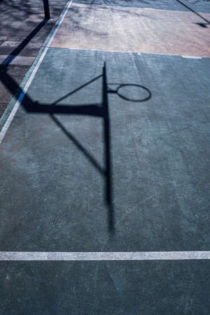 street basketball hoop shadows on the courtの写真素材