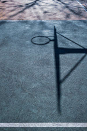 street basketball hoop shadows on the court