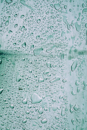 raindrops on the gray metal surfaceの写真素材