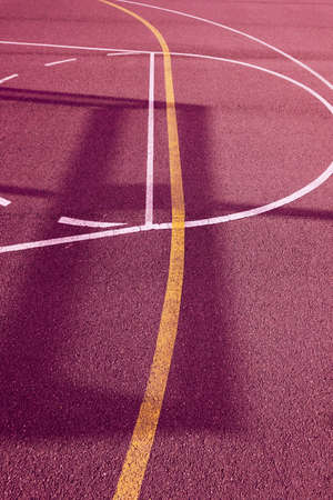 silhouettes on the red street basketball courtの写真素材