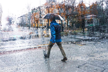 people with an umbrella in rainy days in Bilbao city, Spainの写真素材