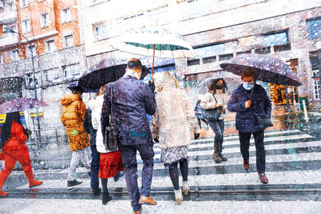 people with an umbrella in rainy days in Bilbao city, Spainの写真素材