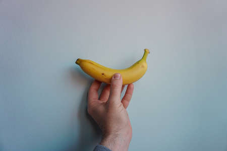 hand holding a banana, healthy fruitの写真素材