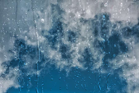 drops on the window and blue sky backgrounの写真素材