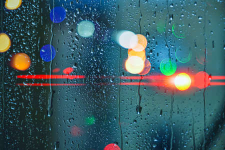 drops on the window and street lights backgroundの写真素材