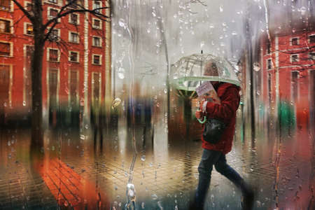 people with an umbrella on the street in rainy days, autumn seasonの写真素材